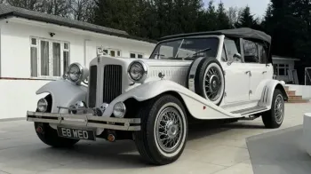 Side view of a Vintage Beauford in Old English White with roof up.