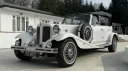 Side view of a Vintage Beauford in Old English White with roof up.