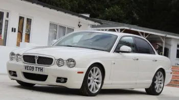White Jaguar XJ front left view showing the twin headlights