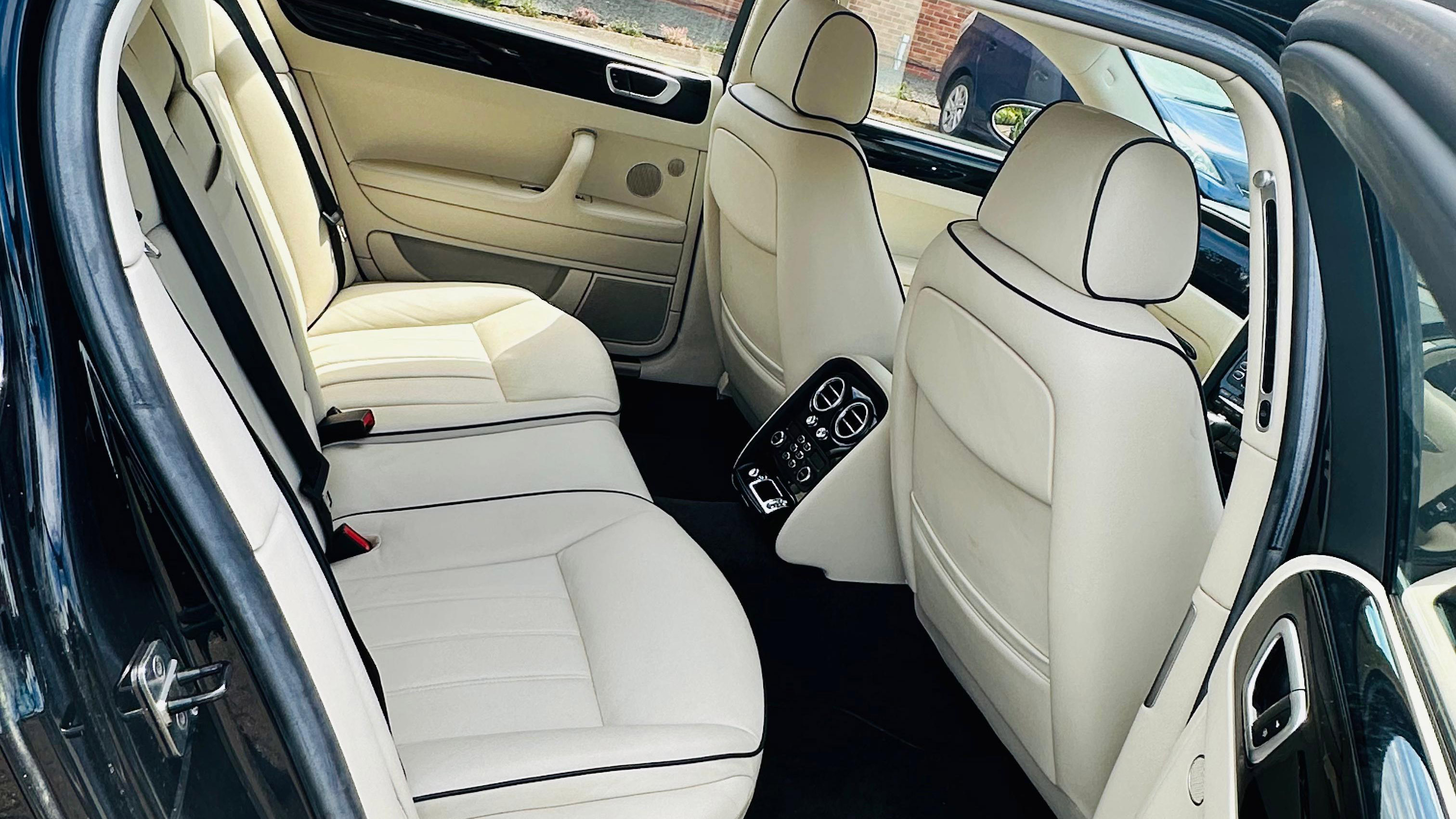 Black Bentley Flying Spur with cream leather interior