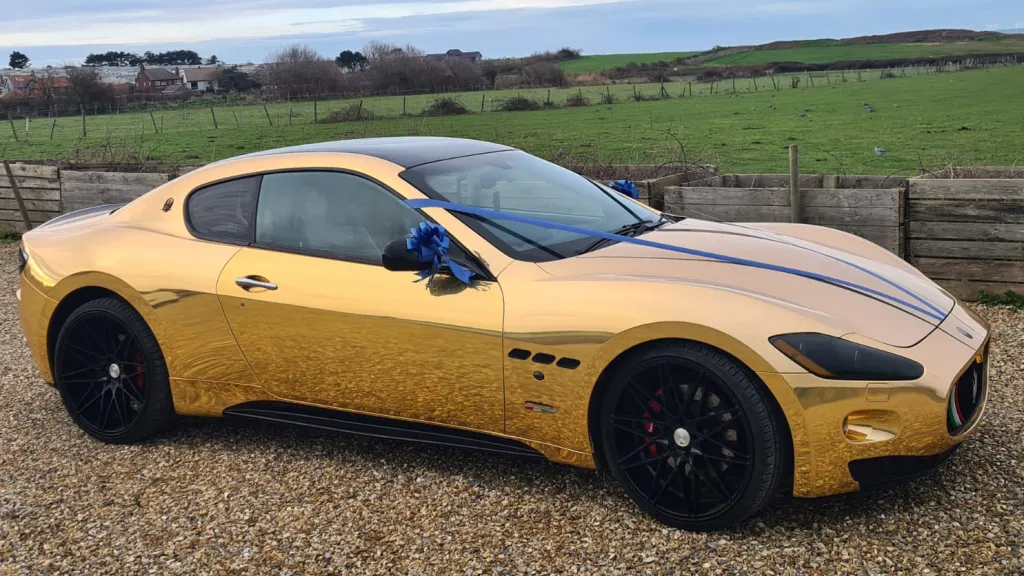 Right side view of Gold Maserati with Dark Blue Ribbons and bows on rear view mirros