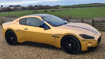 Right side view of Gold Maserati with Dark Blue Ribbons and bows on rear view mirros