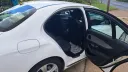 right side rear passenger seating with door open showing black leather seats inside the white mercedes
