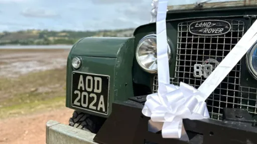 large white bow attached to Landrover bumper.