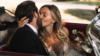 Bride and Groom kissing inside a classic Porsche