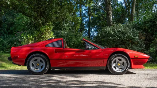Right side view of Red Ferrari with Roof open
