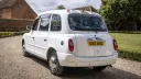 Rear view of white taxi cab at a wedding venue