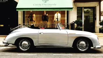 Right side view of classic Porsche 356 with convertible soft top roof down