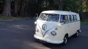 Classic VW Campervan in White and Ivory decorated with white ribbons and bows parked on a drive