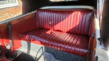 rear interior bench seat in Burgundy inside Beauford convertible.