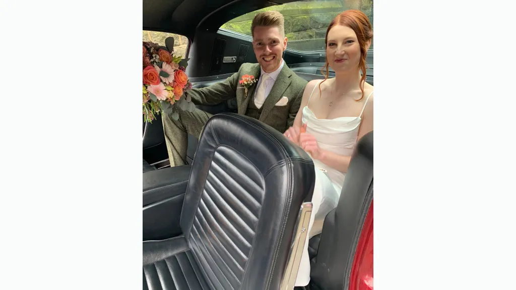 Bride and groom seating inside a classic ford Mustang Fastback, Black Leather Interior