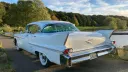 Rear view of White american car with thin tail