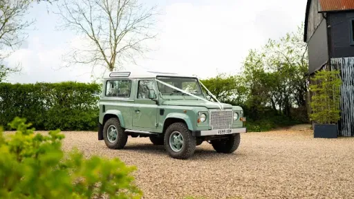 Green Classic defender 90 decorated with white ribbons