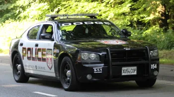 Dodge Charge Pursuit American Police car in Black & White with all the police sign on the side of the doors