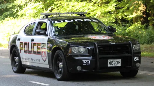 Dodge Charge Pursuit American Police car in Black & White with all the police sign on the side of the doors