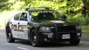 Dodge Charge Pursuit American Police car in Black & White with all the police sign on the side of the doors