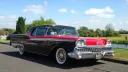 Black and Red American Classic ford Fairlane Skyline with large banded white wall tires.