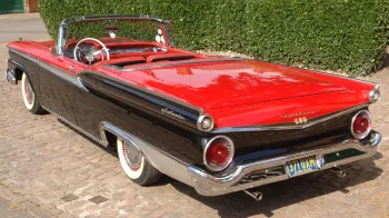 Rear view of American Ford Fairlane in Black with Red Bonnet and boot and convertible roof down
