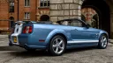 Rear right side view of Ford Mustang with convertible roof open