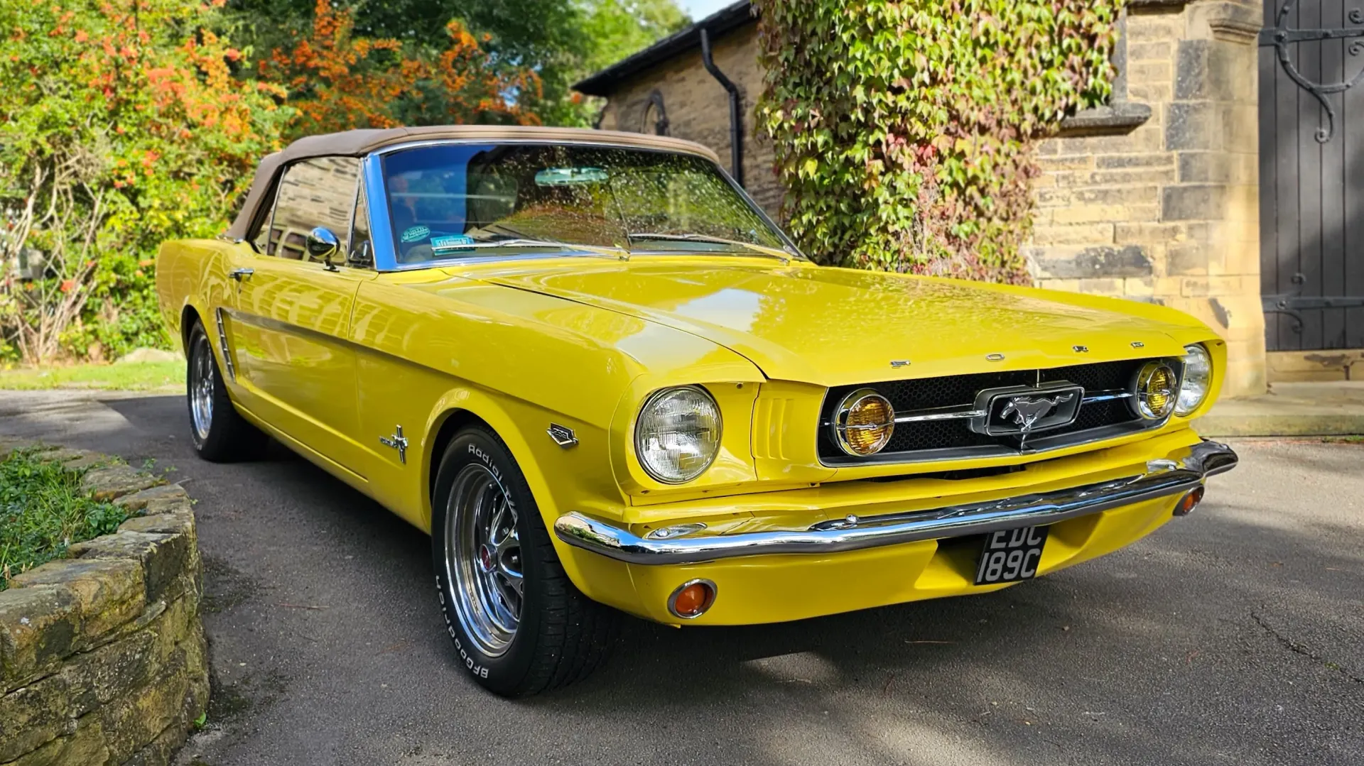 Classic Ford Mustanf in Yellow with convertible roof close