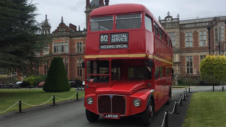Front view of a Red Double Decker routemaster wedding bus at a wedding venue