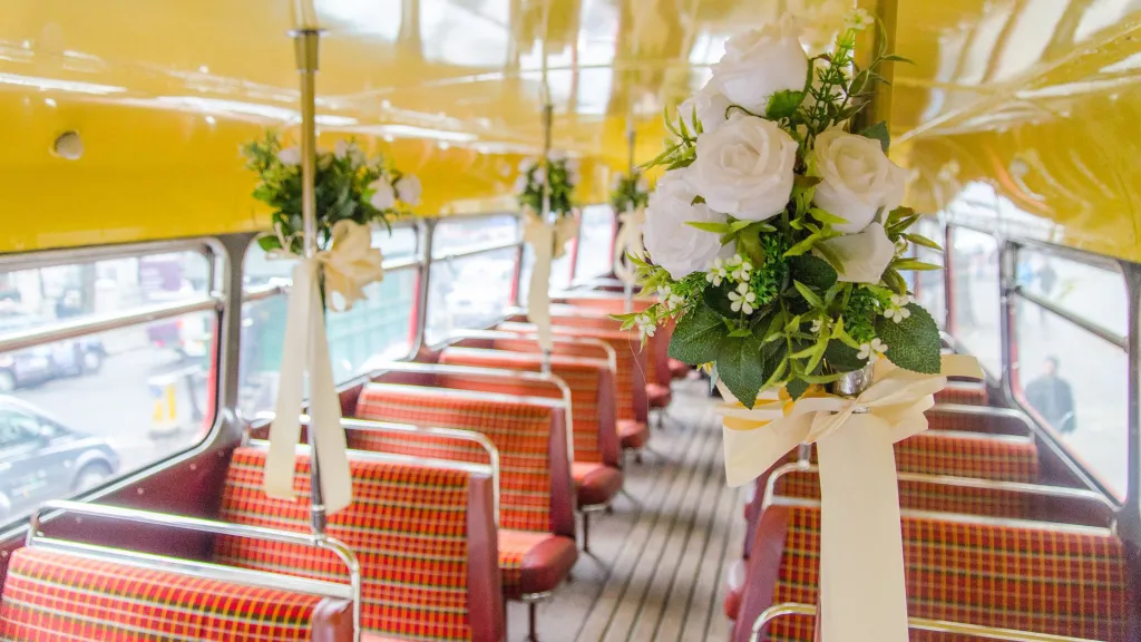 Interior of an old Red London bus decorated with wedding floral decoration