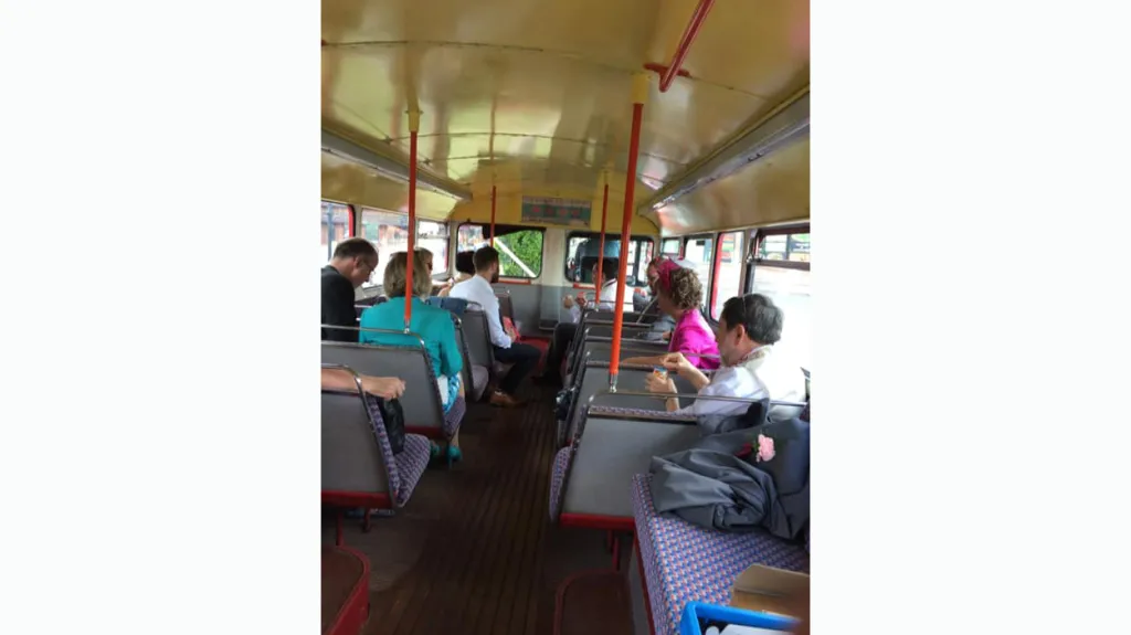Wedding guests seating inside an old Routematser wedding bus
