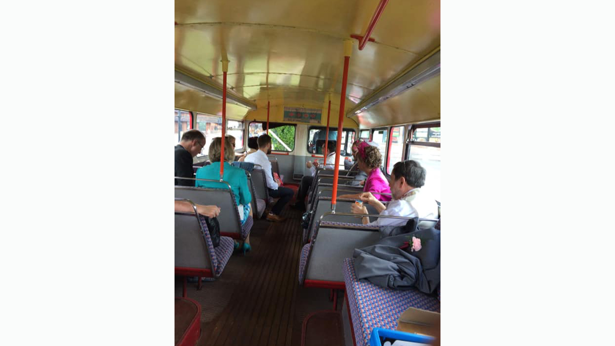 Wedding guests seating inside an old Routematser wedding bus