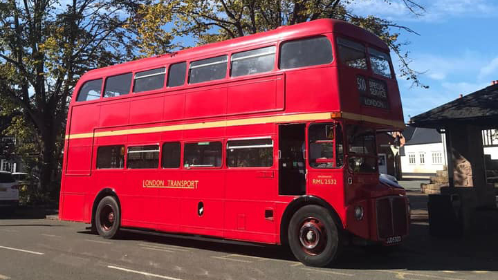 Right side view of an old classic double decker red routemaster bus