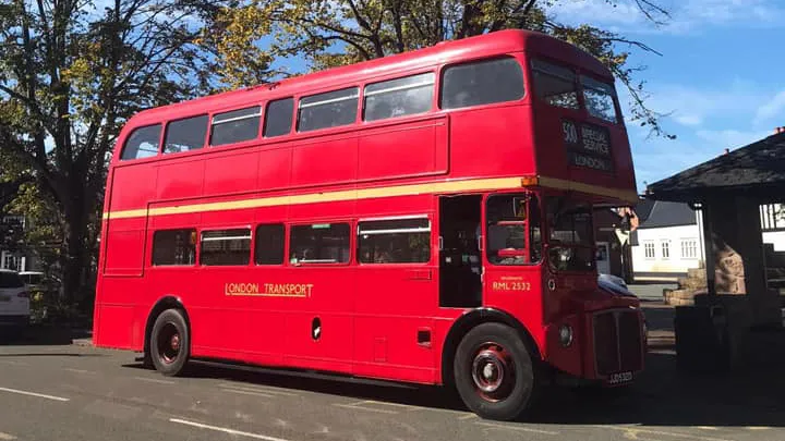 Right side view of an old classic double decker red routemaster bus