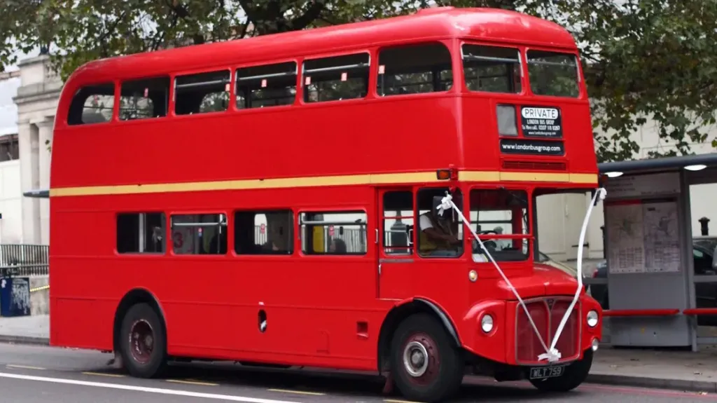 Red Routemaster London bus decorated with White ribbons