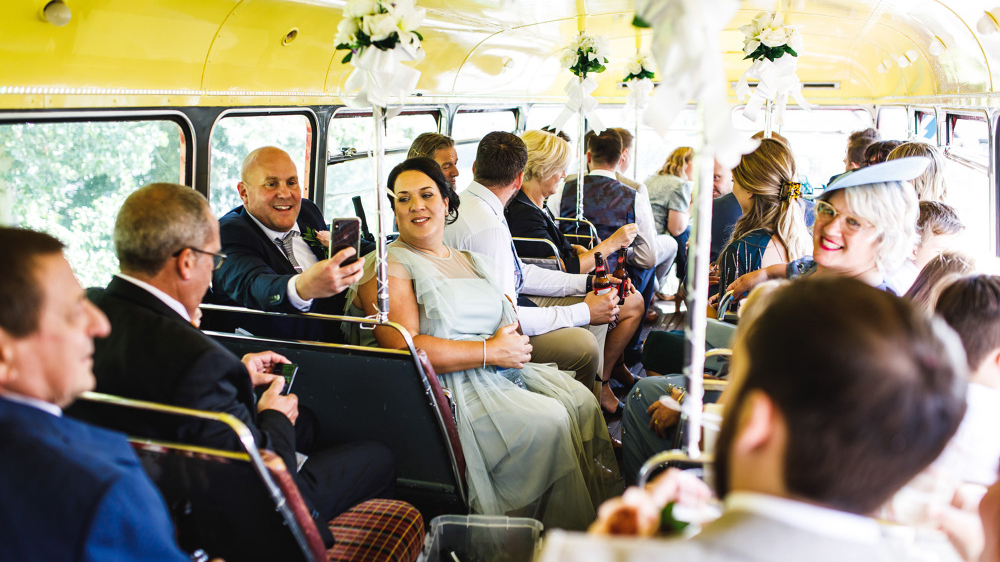 Wedding guests seated inside an old London Routemaster wedding bus