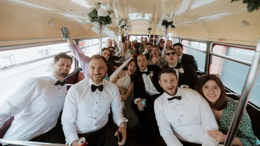Wedding Guests seated inside an old Routemaster Bus