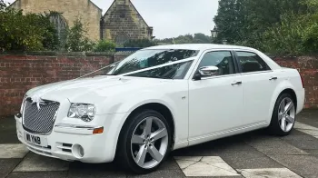 White Chrysler 300c Saloon Car with white weding ribbons