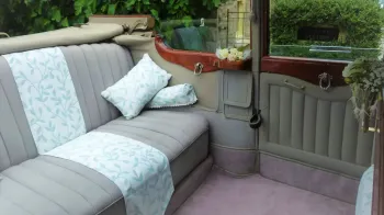 Rear bench seats in Silver inside Vintage Daimler.