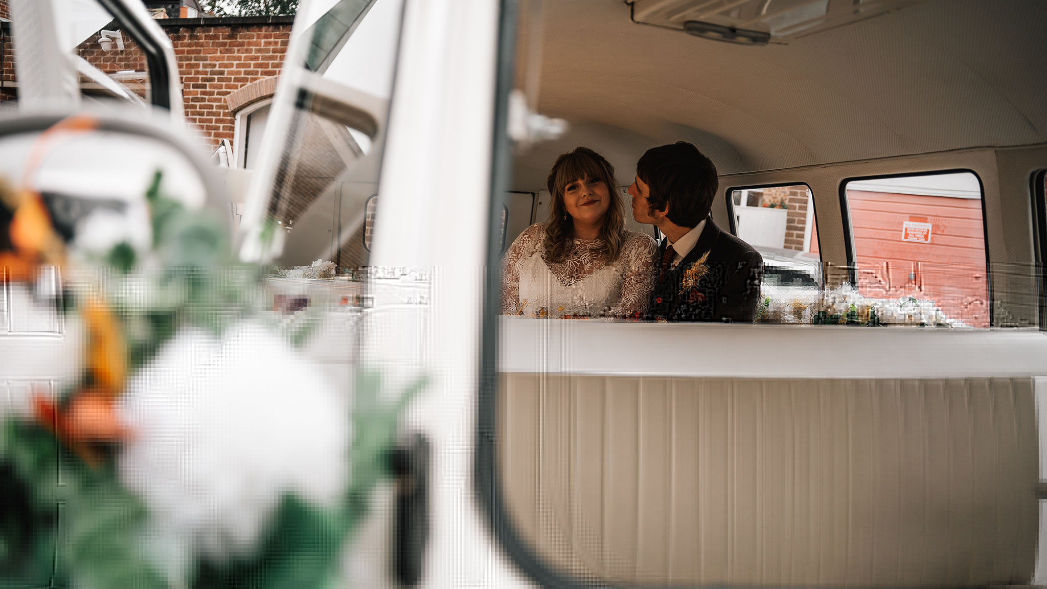 Happy couple seating inside a vw campervan