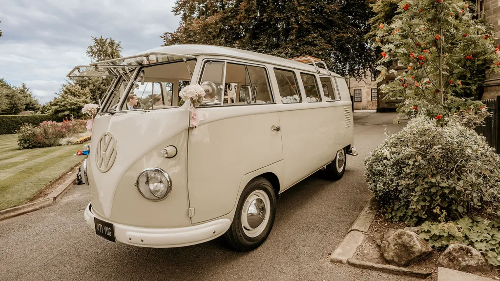 Front left view of classic campervan in two tone white and sage green