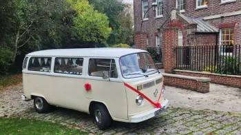 Bright red ribbons and bows on a cream retro classic campervan