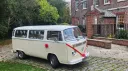 Bright red ribbons and bows on a cream retro classic campervan