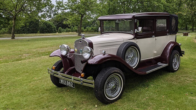 front right view of vintage Badsworth wedding car in Ivory with Burgundy wheel arches and roof