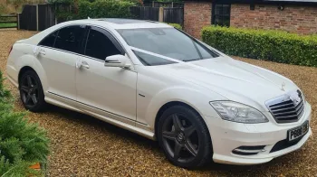 white Mercedes with white ribbons