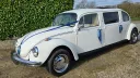Left side view of a stretched classic Beetle Limousine with Royal Blue Ribbons and Bows on door handles