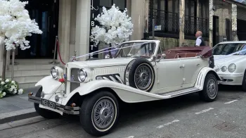 Convertible Beauford with roof down parked in front of a wedding venue in Liverpool showing a Marroon leather interior