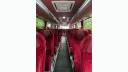 Burgundy seats inside a 55-seater modern Coach