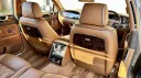 Tan Leather rear interior in Bentley Flying spur with wooden picnic table