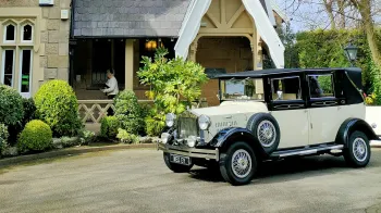 Black and Ivory vintage imperial car with spare wheel mounted on the side of the vehicle