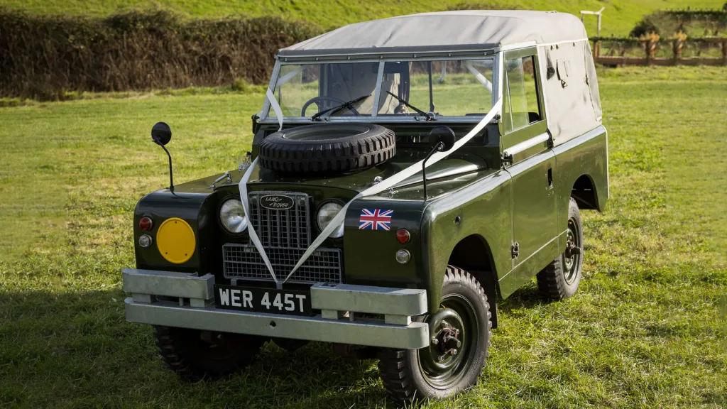 Classic Landrover Series 2 in Army Green with Light grey Canvas decorated with white wedding ribbons