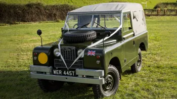 Classic Landrover Series 2 in Army Green with Light grey Canvas decorated with white wedding ribbons