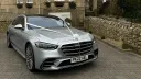 Front view of silver Mercedes decorated with wedding ribbons and bow