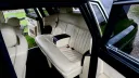 Black Rolls-Royce Phantom with door open showing cream leather rear seating area